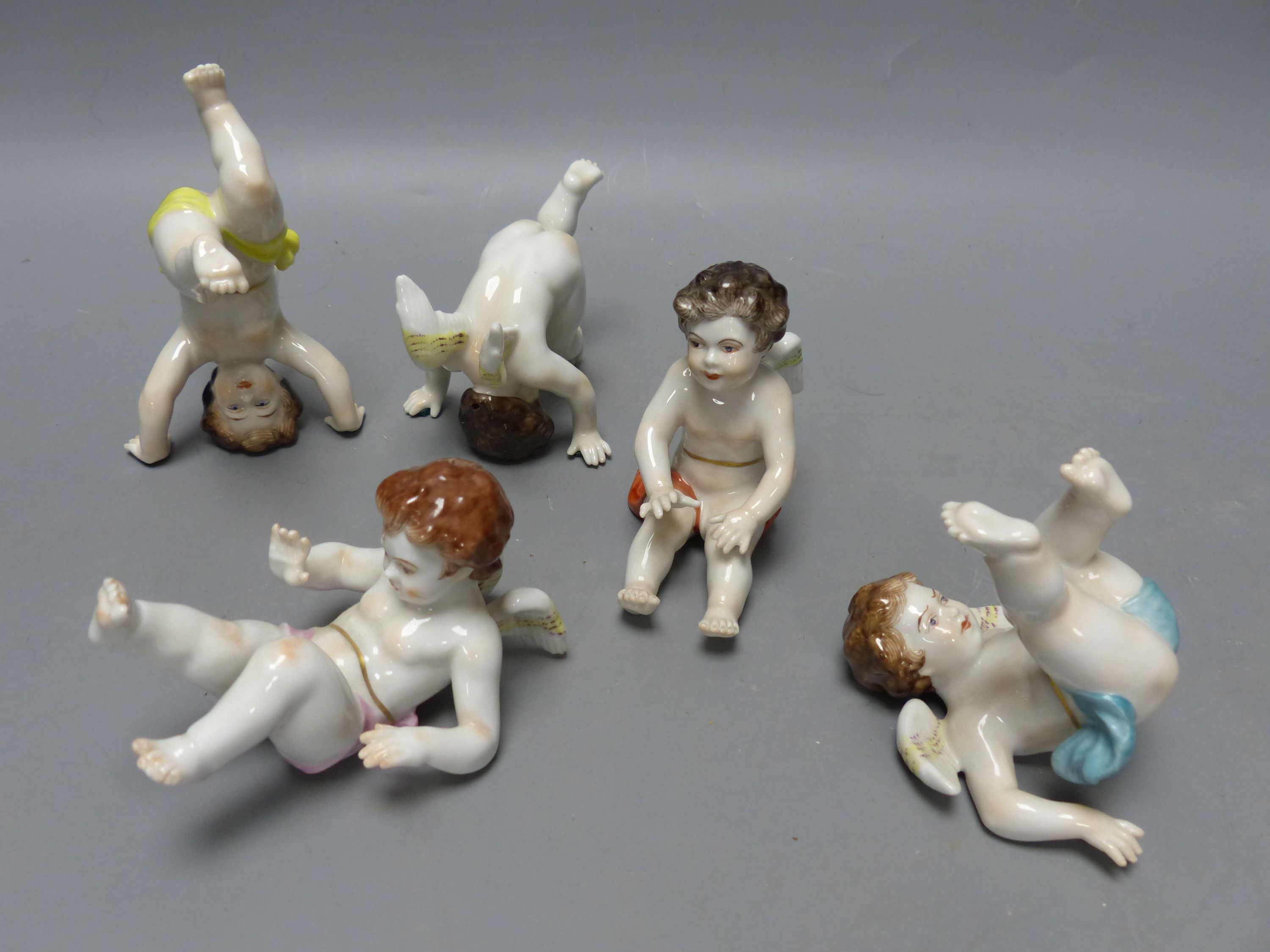 Five Continental porcelain cherubs, tallest 8cm